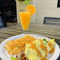 CheezeSteak Omelet with red and green salsa. Freshly squeezed OJ. Shaded patio. #home at Vegan Avenue in San Antonio