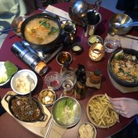 Iron pot 'shared earth' (spicy), vegan no-mince meat  bulgogi w sides included, vegan fries w veganese, last dish unknown. makoli, seoul soul ale & water (162.50 chf)  at Miss Miu - Europaallee in Zurich