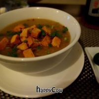 Vegan Arroz Caldo - A big bowl of Filipino rice porridge with shiitake mushrooms topped with fried tofu, crispy garlic and spring onions. at Corner Tree Cafe in Makati