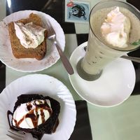 Cardamom cake, chocolate cake and matcha latte, all with vegan cream  at Aum Cafe in Varanasi