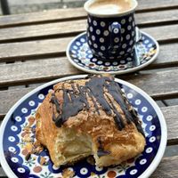Yummy chocolate filled croissant and oat cappuccino   at Vollkornbäckerei Hartwich in Berlin