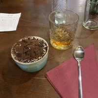 Vegan tiramisu and a glass of whiskey and amaretto  at Sora Lella Roman Vegan Restaurant in Edinburgh