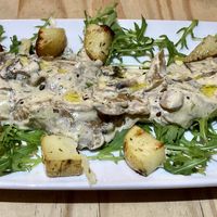 Seitan in mushroom sauce with rocket and roast potatoes.  at Sora Lella Roman Vegan Restaurant in Edinburgh