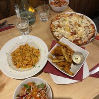 Pizza , pasta and homemade chips with a tomato side salad.   at Sora Lella Roman Vegan Restaurant in Edinburgh
