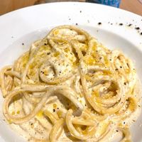 BUCCATINI CACIO E PEPE - classic Roman pasta recipe made with parmesan, black pepper and truffle sauce. at Sora Lella Roman Vegan Restaurant in Edinburgh