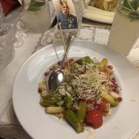 "Asparagus & Couscous" with roasted, caramelized green asparagus,
grilled cherry tomatoes, pomegranate seeds, and toasted almond flakes (seasonal dish)  at Marchfelderhof in Deutsch-wagram