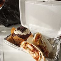 Crispy BBQ chicken wrap and jumbo chocolate cupcake. at Yes It's Fresh in Cleveland