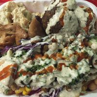 Falafel platter with Baba Ganoosh, pita chips, salad and so much tahini and hot sauce  at Falafel Tarboosh in New York City