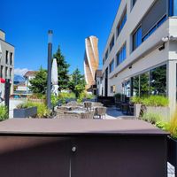 Outdoor seating in the back at Scanaua in Schaan