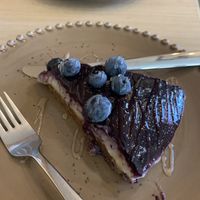 Like a cheesecake but made with coconut and blueberries yummy 😋   at Raiz in Aveiro