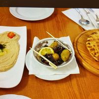 Best hummus ever with mixed olives and homemade soft pitas at Art Corner Cafe in Vienna