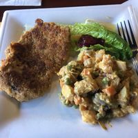 Schnitzel with potato salad and cranberry sauce  at Manna Kitchen in Lisle