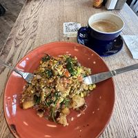 Oat cappuccino and vegan hash of scrambled tofu, mushrooms, onions, tomatoes, spinach, cauliflower, potatoes, and vegan sausage.  at Busboys and Poets - Mount Vernon Triangle in Washington