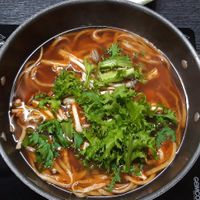 Dotori kalguksu with fresh chicory and mushrooms, torn in bite size pieces at Dotori Kalguksu in Seoul