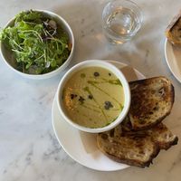 A bowl of the corn chowder, side of sourdough, and side salad. This was an 11/10!! at Lula Cafe in Chicago
