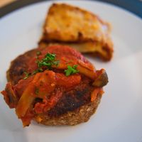 Hamburg Steak is topped with savoury tomato and mushroom sauce. at Upgrade Plant Based Kitchen in Osaka