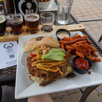 Housemade southwest burger with sweet potato fries, and a flight of the house beers. at BrickHouse in Patchogue