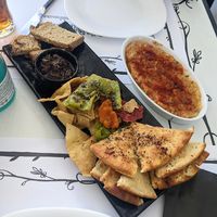 Local pittas with olive dip, and a bowl of aubergine dip on the right at Tis Mammis Sou in Rhodes