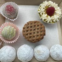 Matcha, hibiscus, and London fog tea cookies. Pandan and raspberry truffles, mango and matcha tartlet. Nutter Butter alternative made in house cookie sandwich.   at Askatu in Seattle