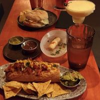 chicken burger, sausage, tequeños, cocktails and tap water at Vyb Bar in Barcelona