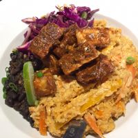 Dinner special, vegan option, by Chef Chris at Nine Mile West: Jerk tofu over a sauté of peppers, carrots, and mango tossed with rice in a red curry coconut sauce; served with black beans and a currant-apple slaw.  at Nine Mile Montford in Asheville