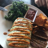 Breakfast burrito with really yummy kale, sausage my son even ate, sweet potato chips and salsa. Mmmm! at Cafe Sunflower in Atlanta