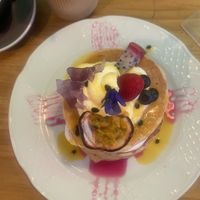Alice stack pancakes (with passion fruit coulis and violet sugar bark & vegan Chantilly cream) 🤤   at Frutas Prohibidas in Madrid