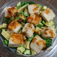 Vegan and gluten-free poke bowl with tofu, broccoli, edamame, spring onions, avocado with a sweet pomegranate chilli sauce at Wildflower Poke & More in Dubai