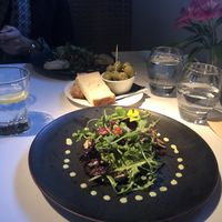  Marinated aubergine with green tahini dressing. Side of olives and gluten free sourdough. at Fellinis in Ambleside