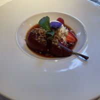 Poached pear in red wine sauce with vegan ice cream  at Fellinis in Ambleside