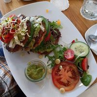 Hash browns with guacamole & veggies. at California Bean in Munich