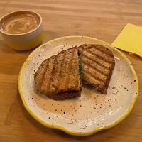 Sandwich vegano y capuccino con leche de sona  at Mia in Malaga