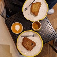 Banana bread and coconut plumcake. Cappuccino with almond milk. at Mia in Malaga