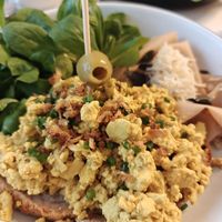 Vegan scrambled eggs, salad, seitan ham, on bread at Pepper & Ginny - Vegane Veinkost in Vienna