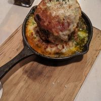 Stacked avocado, tomato, and cheese baked in the pizza oven at Tierra in Osaka