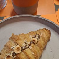 Croissant with hezelnut cream and an oat milk cappuccino at Wild Souls in Athens