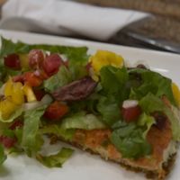 Raw vegan pizza slice 🍕   at Tehuti Cafe in Kingston