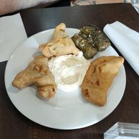 Stuffed vine leaves, hummus and fatayer (left; the beignet on the right is not vegan) at Aux Vieux Cèdres in Paris