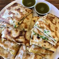 Vegan Bolani (sub extra cilantro chutney for cow yogurt). It’s good, but it’s definitely not a full meal. This gigantic plate of bread is to be shared among 4 people at least.  at House of Shah in Woodland