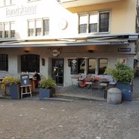 Exterior and outdoor seating at the square at Cafe Henrici in Zurich