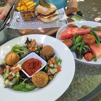 Vegan Spicy Tofu burger, Vegan pesto macadamia arancini balls, Vegan option spicy tofu bites 'grilled haloumi salad' at Hanging Rock Cafe in Woodend