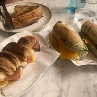 A baguette, a croissant, and a piece of savory pie from the counter  at The Vegan Corner in Barcelona