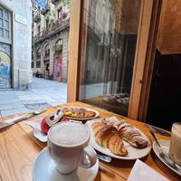 Vegan croissant options (plain, chocolate & vegetable breakfast sandwich), vegan red velvet donut & cake, cappuccino & iced latte with oat milk  at The Vegan Corner in Barcelona