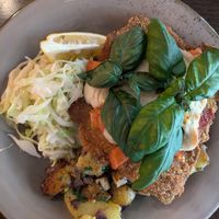 Schnitzel with vegan mozzarella, tomatoes, and coleslaw at Försters in Berlin