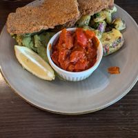 Schnitzel with roasted tomatoes and peppers, cucumber salad, and German roast potatoes at Försters in Berlin