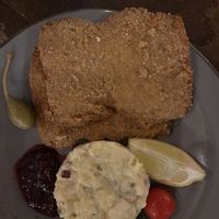 Schnitzel (escalope panée). Served with cucumber salad  at Försters in Berlin