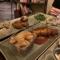 Bread plate in front (hard to see,) schnitzel with potato salad, currywurst and fries, champignons baguette with cheese at Försters in Berlin