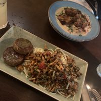 A chanterelles pesto sause on noodles with medallions of seitan and bread dumplings with a chanterelles cream sauce and smoked tofu at Försters in Berlin