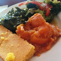 Veggie sampler plate - what the non-vegan ordered. Why some people have a "thing" about eating vegan amazes me! It's just food, cruelty free. Moist, tasty cornbread, with sweet potatoes, collard greens and a broccoli stir-fry. She kept inspecting every bite of the stir-fry looking for hidden tofu - really... at Soul Vegetarian - South in Atlanta