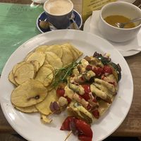 Robi skewers, potato, ”cheese” sauce. The cappucino was not good.   at Vegalite in Brno
